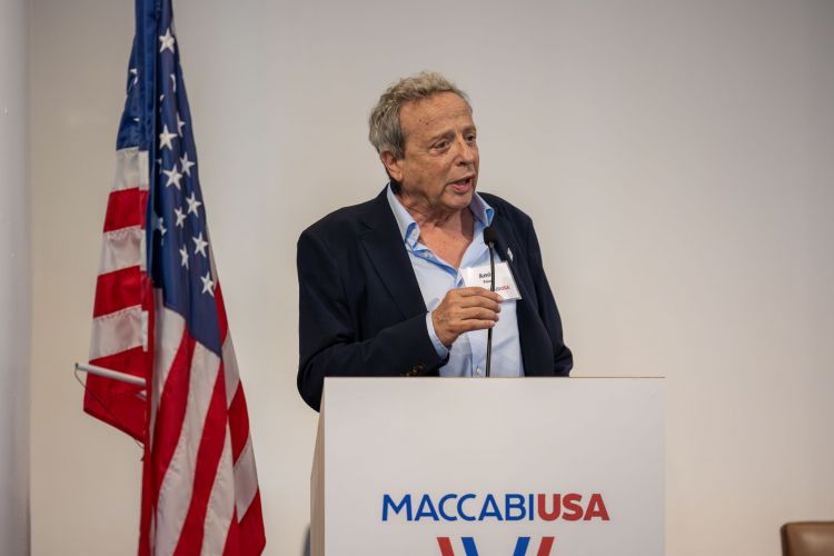 Amir Peled talks at podium