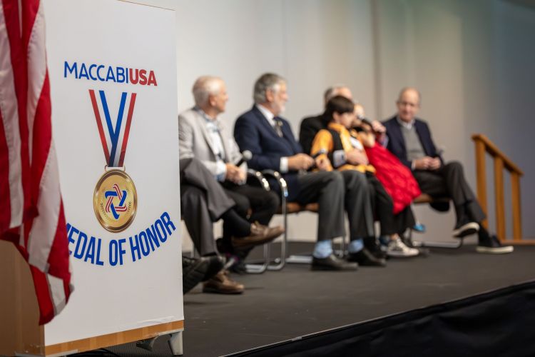 MOH signage with panelists in background