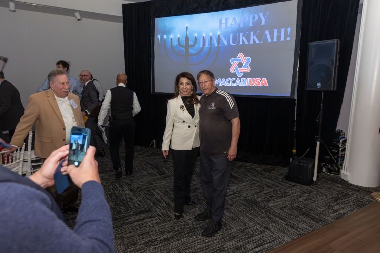 Stuart Weitzman Talia Carner with Happy Hanukkah sign above