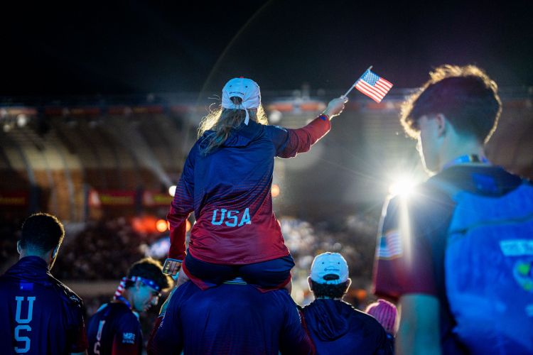 Great shot from behind girl on shoulders waving USA flag during walkout at Opening Ceremony DSC00564