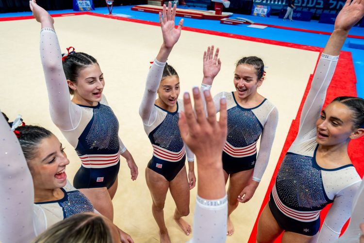 MUSA Gymnastics team hands in air huddle DSC03180